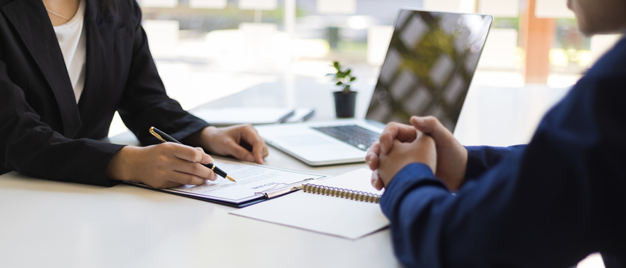 Two Employees Discussing Business Papers Two Employees Discussing Business Papers
