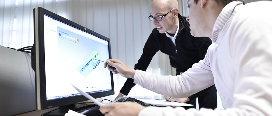 Two Engineers Working on Computer Screen